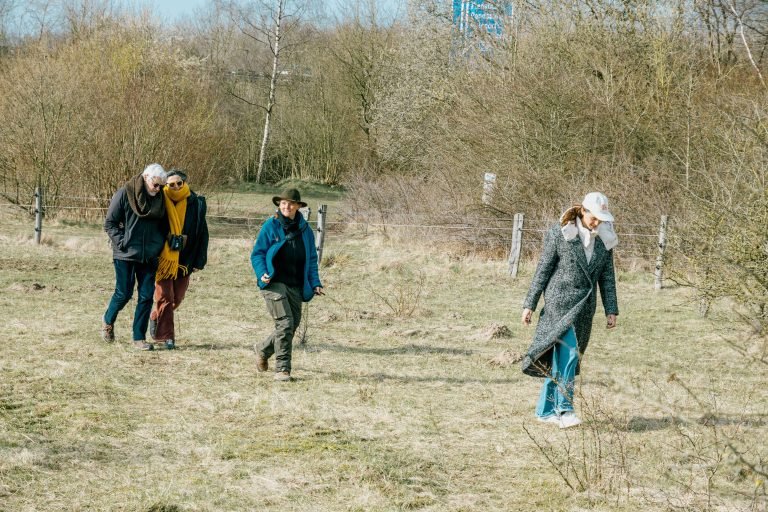 A group of people walking on a pasture.