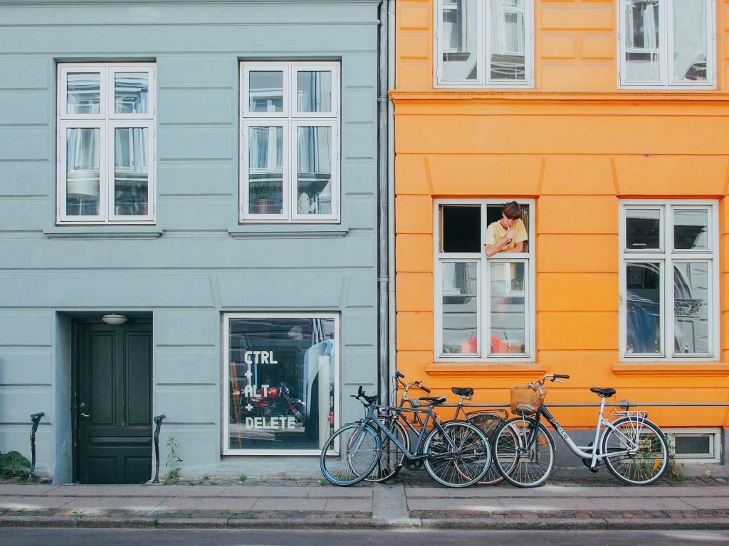 colourful houses in the city of Copenhagen with bikes parked in fron of the houses.